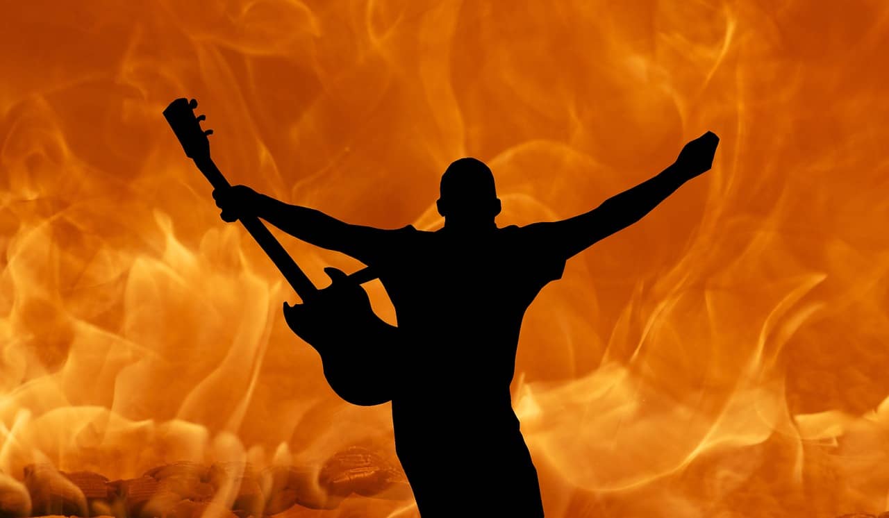 Everything you need to know about live music shows Man holding guitar